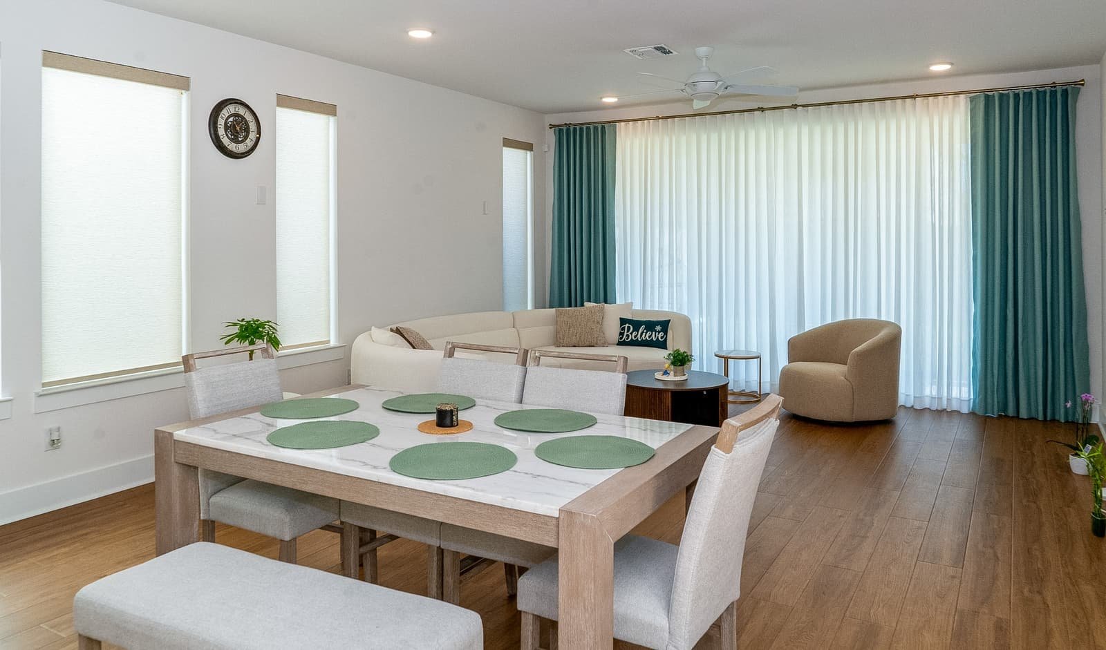 Living room in a Dallas-Fort Worth home with custom plantation shutters filtering afternoon light