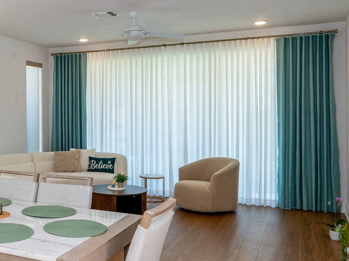 Custom drapery panels on a motorized track in a DFW living room